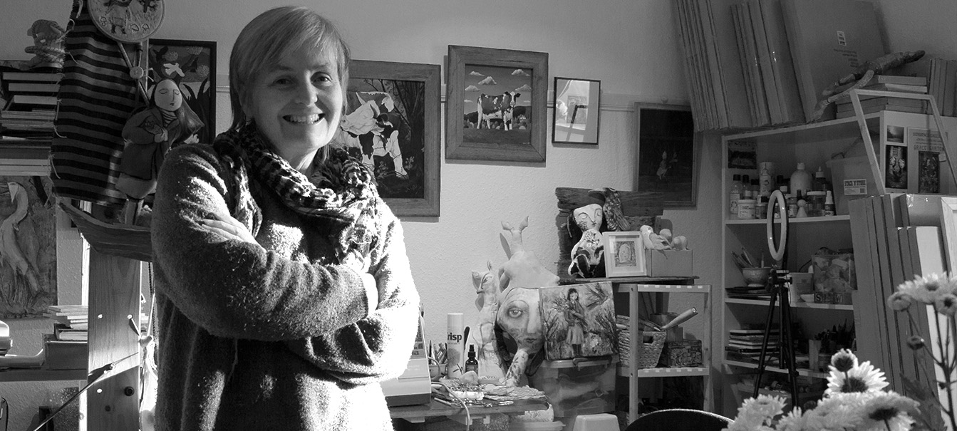 A black and white portrait photo of Grace Garton in her art studio.