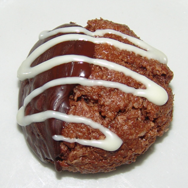 One chocolate macaroon with white and chocolate icing.
