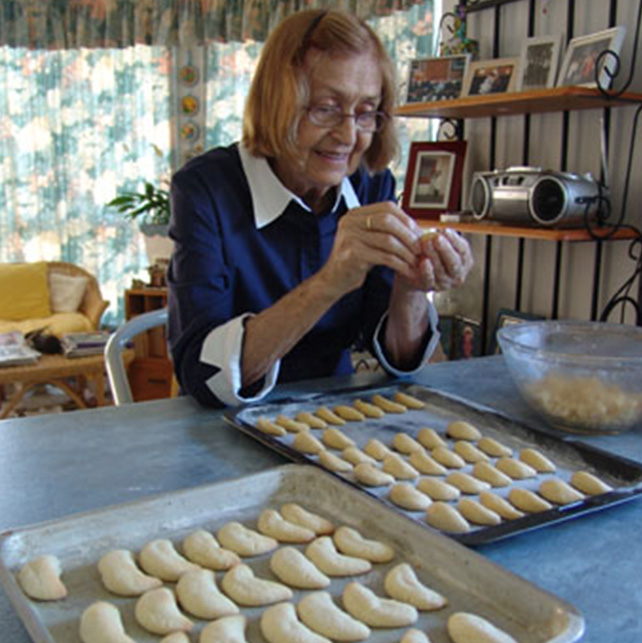 My mother making almond half moon biscuits